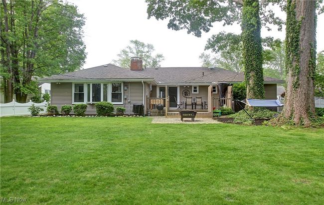 Rear view of property with a chimney, roof with shingles, and a patio | Image 43