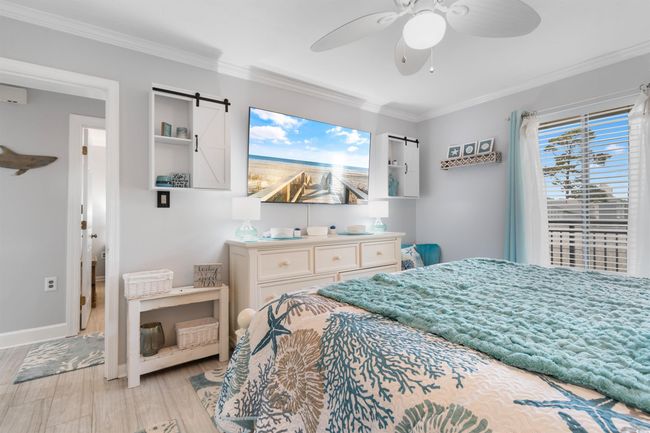 Bedroom featuring ornamental molding, light wood finished floors, ceiling fan, and baseboards | Image 14
