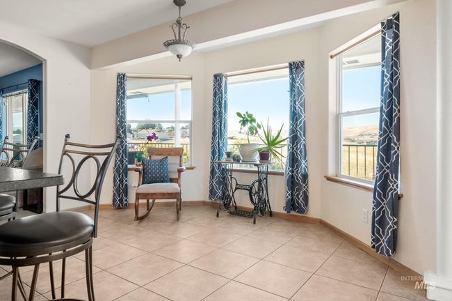 Light filled breakfast nook space featuring tiled floors and arched walkways | Image 15
