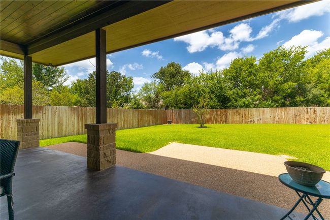 Step outside to a cozy patio that is an ideal space to relax, unwind, or entertain guests in privacy and comfort. | Image 26