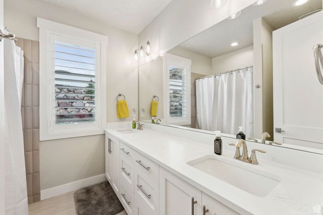 Bathroom featuring baseboards, a wealth of natural light, and a sink | Image 19
