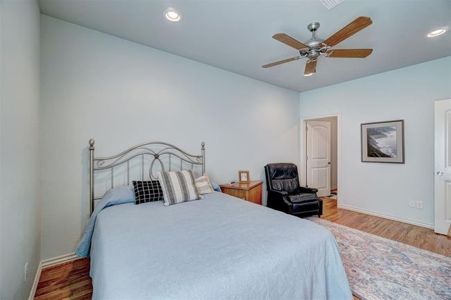 Bedroom with ceiling fan, baseboards, wood finished floors, and recessed lighting | Image 35