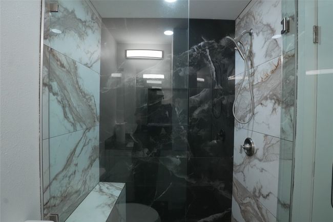 Bathroom featuring a marble finish shower and toilet | Image 12