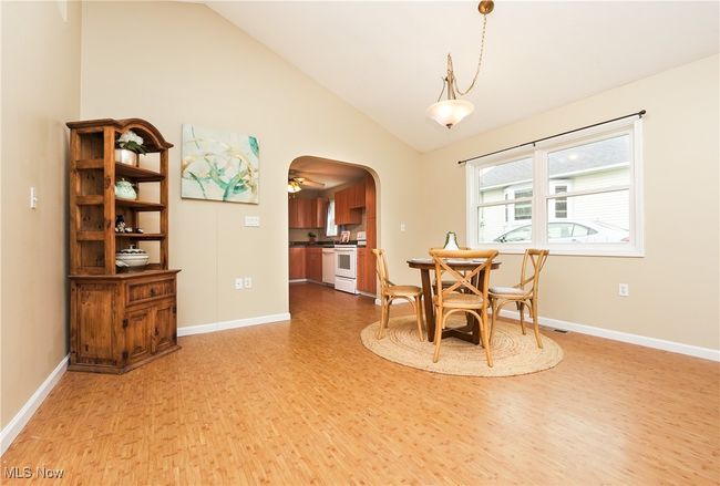 Dining area with baseboards, lofted ceiling, and light wood-type flooring | Image 9