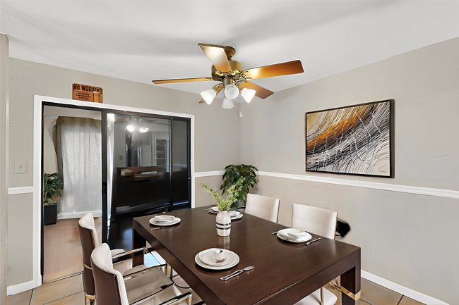 Dining area featuring a ceiling fan, tile patterned floors, and baseboards | Image 6