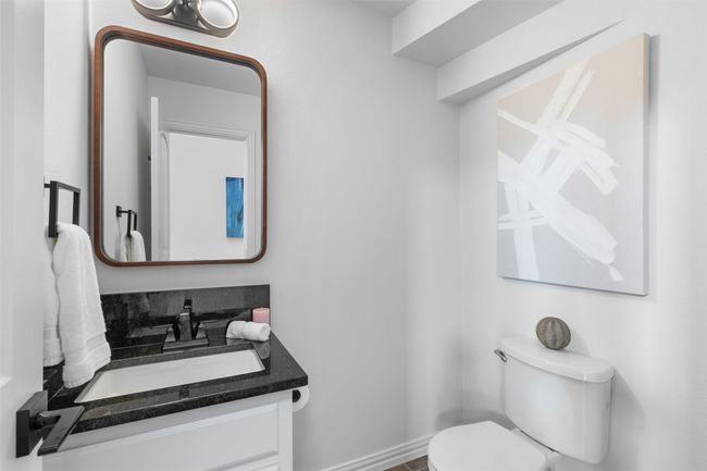 Half bathroom with vanity, toilet, and baseboards | Image 11