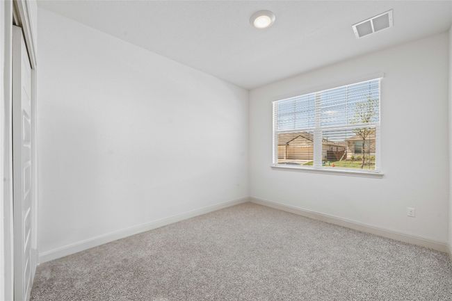 Empty room with carpet, visible vents, and baseboards | Image 4