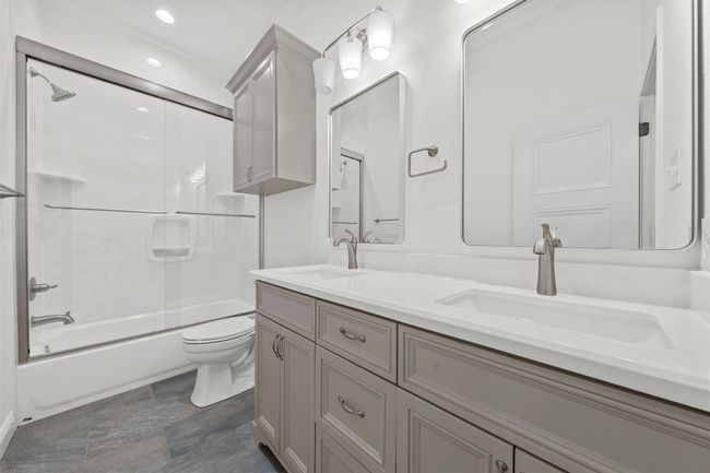 Bathroom with double vanity and shower / bath combination | Image 24