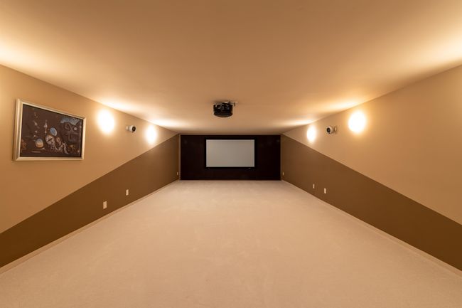 Home theater with vaulted ceiling and light colored carpet | Image 33