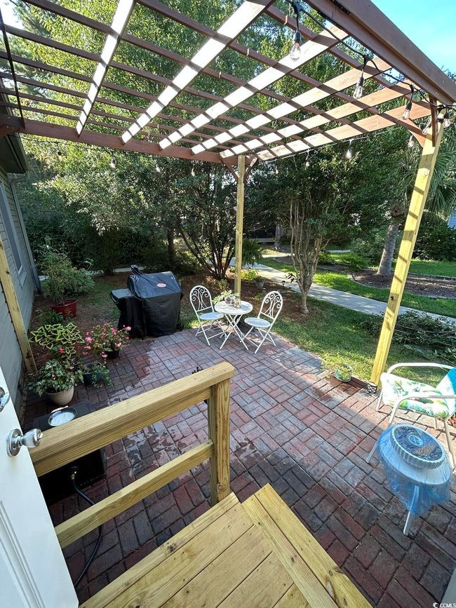 View of patio featuring a pergola and grilling area | Image 31
