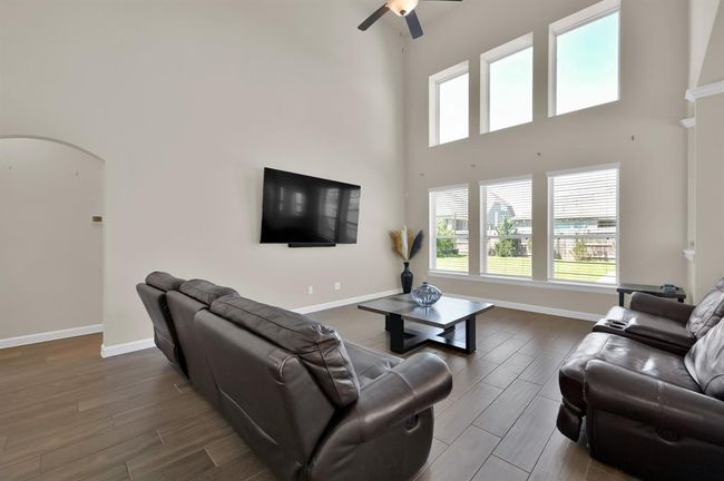 This large 17 x 15 living area is perfectly setup to accommodate a large entertainment area. Before we run off to view the primary bedroom, let's make note that the floor outlets make it convenient for lamps, furniture, or electronics. | Image 14