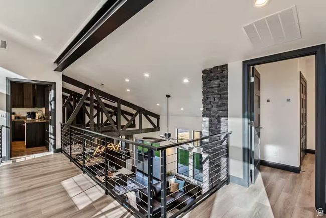 Hall featuring recessed lighting, visible vents, light wood-style flooring, and an upstairs landing | Image 33