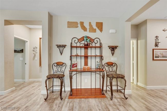Sitting room featuring baseboards and wood finished floors | Image 7