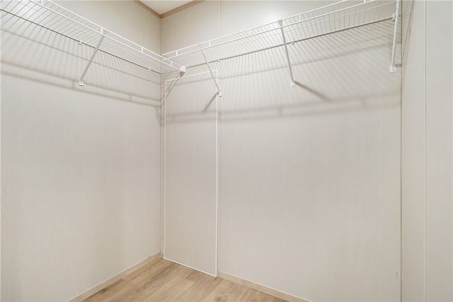 Spacious closet with light wood-style flooring | Image 24