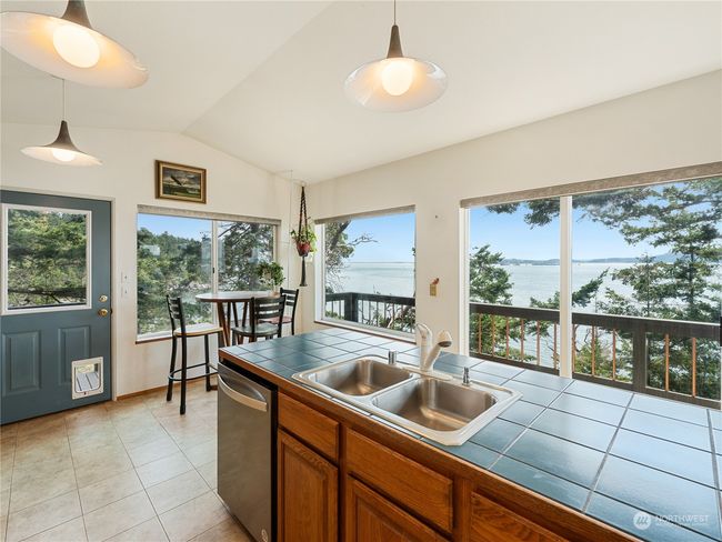 The back door leads around to the front deck & fenced-in area. | Image 16