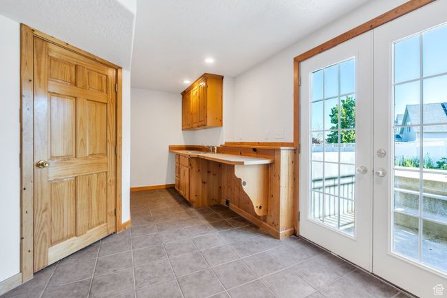 Bar area with healthy amount of natural light, light tile patterned flooring, french doors, recessed lighting, and baseboards | Image 18