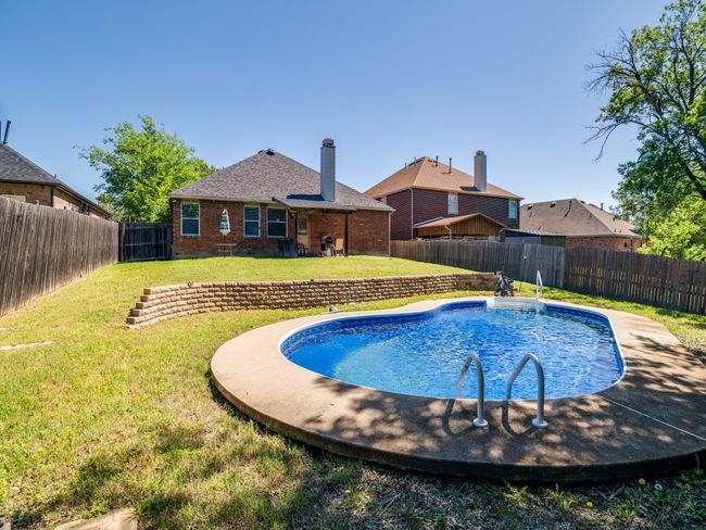 View of pool with a fenced backyard, a fenced in pool, and a yard | Image 22