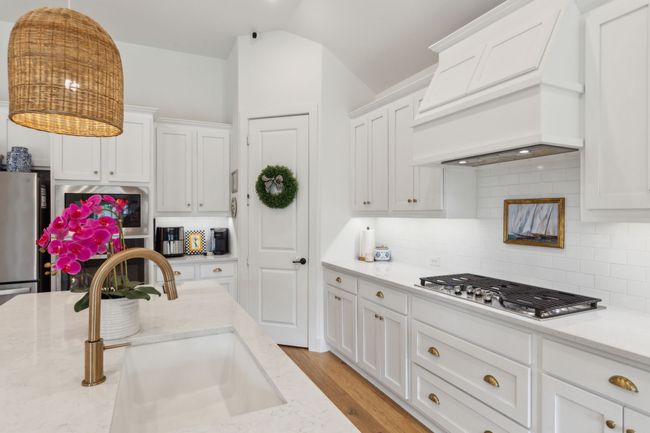 Upgraded chef's kitchen with soft close drawers, 5-burner GE gas cooktop and upgraded exhaust vent-a-hood. The walk in pantry includes a plug for your appliances = SO SMART! | Image 7