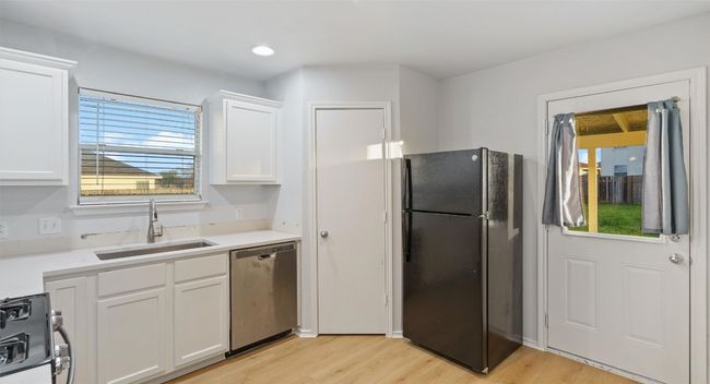 Kitchen with freshly painted cabinets. | Image 12