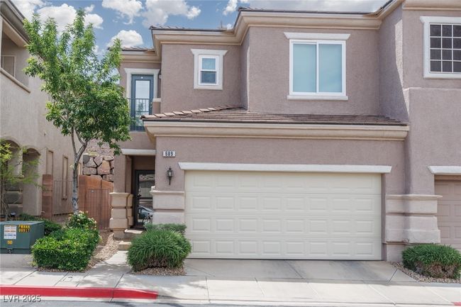 View of front of property with an attached garage, a tiled roof, driveway, and stucco siding | Image 4
