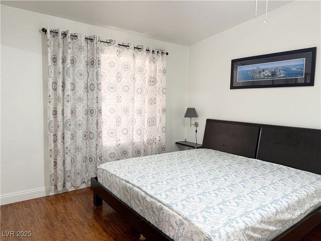 Bedroom with baseboards and wood finished floors | Image 24