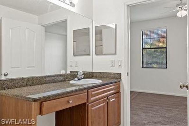 Bathroom featuring baseboards, a ceiling fan, and vanity | Image 22