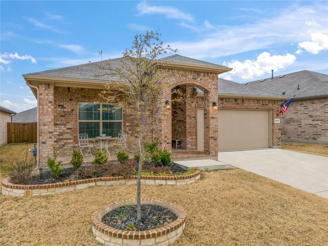 View of front of home featuring brick siding, fence, roof with shingles, a garage, and driveway | Image 30