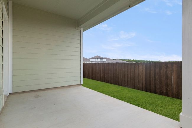 Fenced backyard with a patio | Image 34