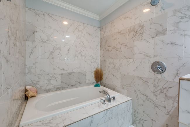 Bathroom featuring tile walls, crown molding, and shower with separate bathtub | Image 19