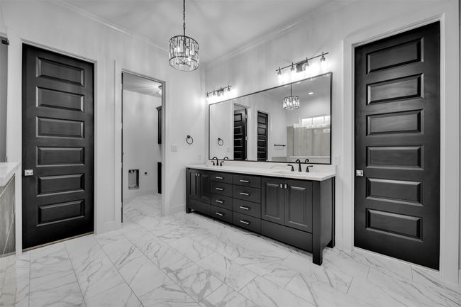 Bathroom featuring crown molding, a sink, marble finish floor, double vanity, and an inviting chandelier | Image 15