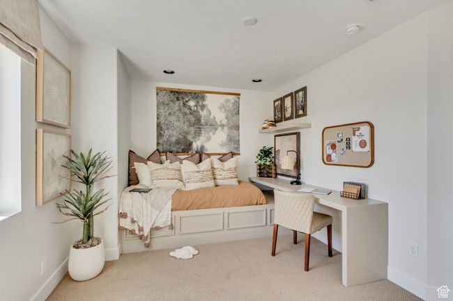 Carpeted bedroom with a desk and baseboards | Image 17
