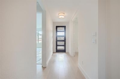 Foyer with light hardwood / wood-style floors and modern entry door | Image 2