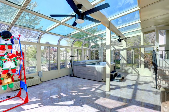 Sunroom / solarium with a ceiling fan and a hot tub | Image 27