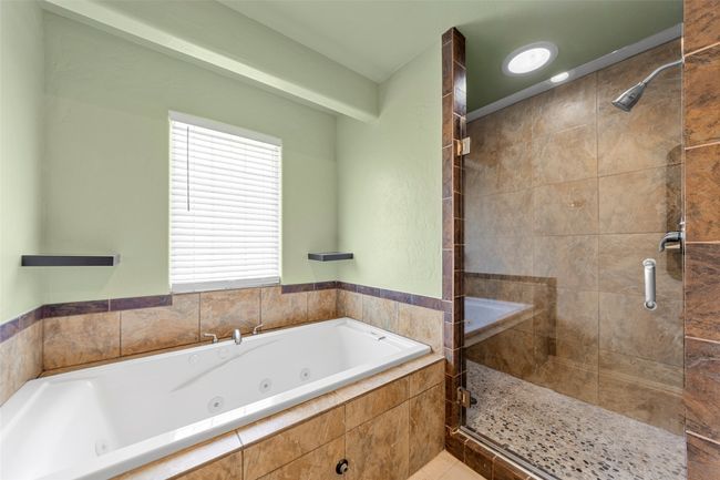 Bathroom featuring a shower stall and a whirlpool tub | Image 17