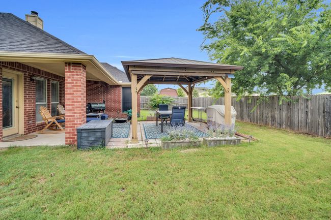 Fenced backyard featuring a gazebo and a patio | Image 34