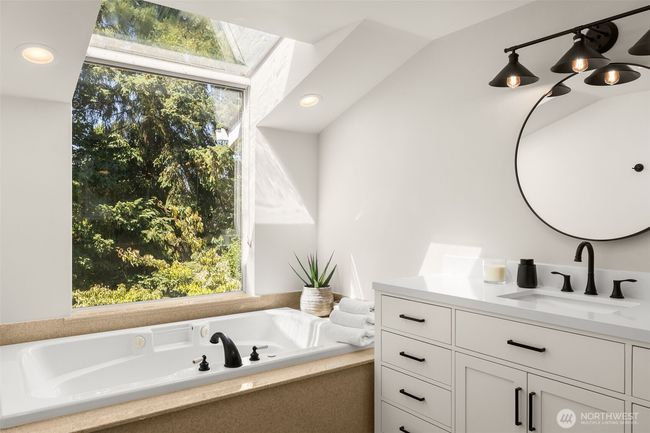Your personal retreat features a one-of-a-kind window framing vibrant greenery, with a deep soaking tub perfectly positioned for tranquil, starlit evenings. | Image 16