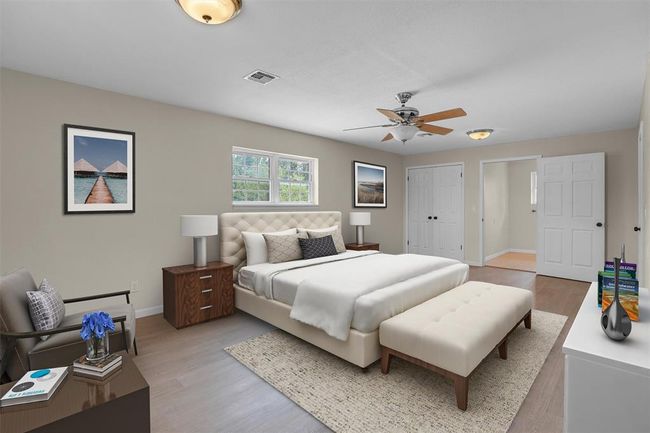 Bedroom featuring light wood-type flooring, ceiling fan, and a closet | Image 26