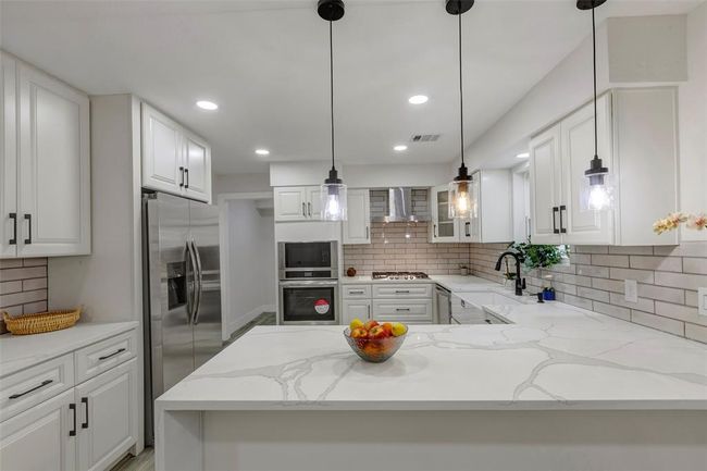 Chef's dream kitchen with new appliances, beautiful Quartz countertops, light fixtures and cabinets. | Image 15