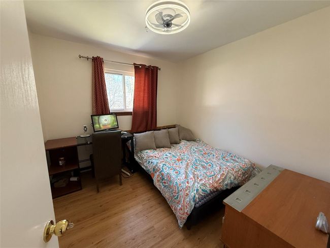 Bedroom with a baseboard radiator and light wood-style floors | Image 11