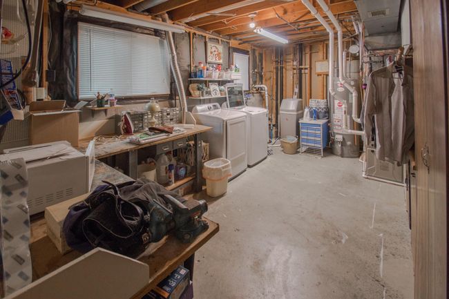 Utility and laundry room features workshop space with a workbench | Image 19