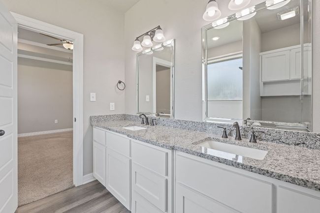 Full bath featuring double vanity, ceiling fan, and wood finished floors | Image 22