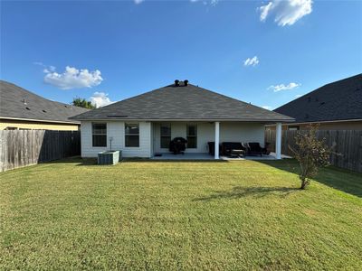 Back of house with outdoor lounge area, a yard, a patio, and central air condition unit | Image 3