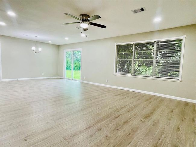 Another view of the living room and dining room area offering an open concept | Image 16