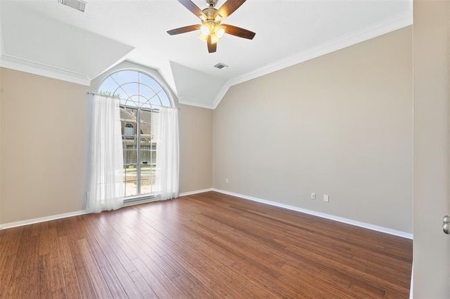 Primary bedroom (down) with walk in closet and primary bath access | Image 7