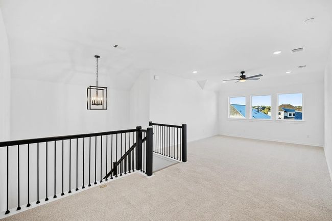 Hallway with an upstairs landing, carpet, a chandelier, and recessed lighting | Image 5