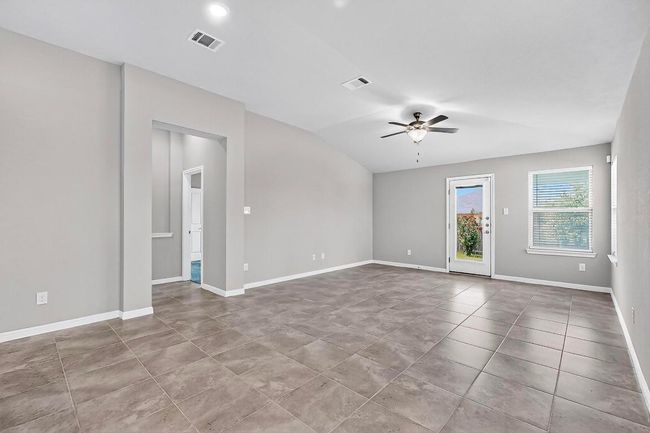 Spare room featuring ceiling fan, lofted ceiling, and tile patterned flooring | Image 8