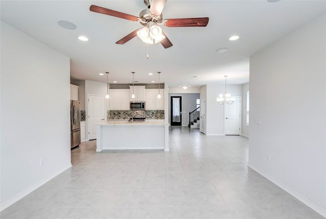 Kitchen with appliances with stainless steel finishes, tasteful backsplash, recessed lighting, light countertops, and ceiling fan | Image 8
