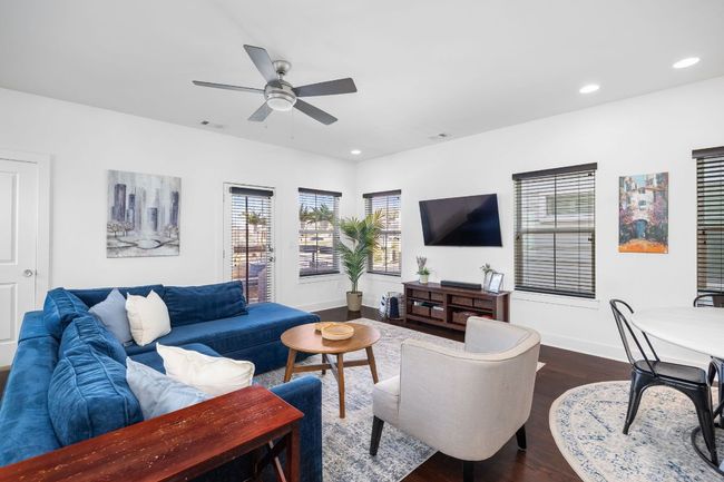 Living room features modern light fixtures, ample windows for lots of natural light. | Image 17