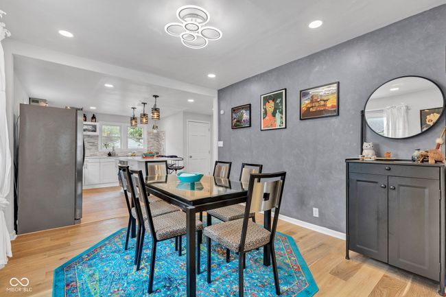 The dining room filled with natural light and easy access to the gourmet open kitchen. | Image 8
