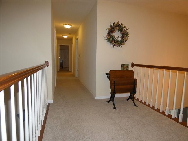 The upper-level features a loft w/views of the open floor plan below | Image 27